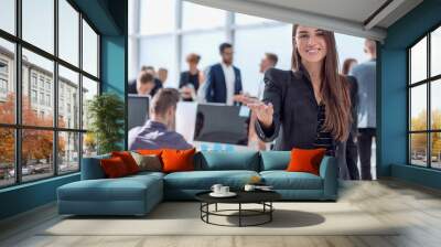 smiling friendly business woman on the background of the office. Wall mural