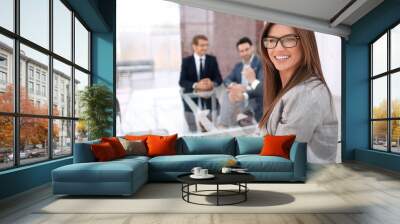 successful business woman sitting at a table in the meeting room Wall mural