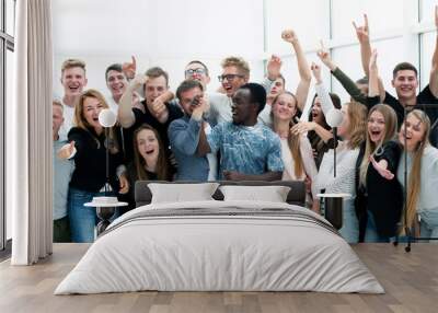 team of happy young people showing their success Wall mural