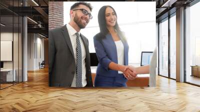 two beautiful businesswomen handshaking in office Wall mural