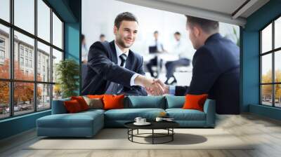 Two business colleagues shaking hands during meeting Wall mural