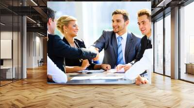 Two businessmen handshaking after striking grand deal Wall mural