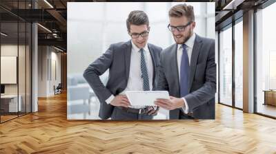 two colleagues looking at the digital tablet screen Wall mural