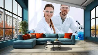 two scientists biologists sitting in a laboratory. Wall mural