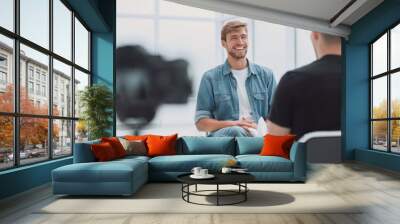 two young men talking in the TV Studio Wall mural