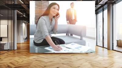 Woman assistant at the workplace in the office Wall mural