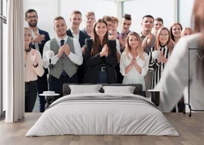 young business woman looking at her business team. Wall mural