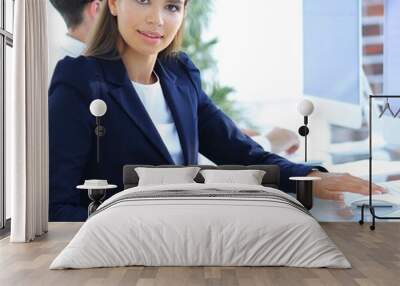 young business woman sitting at desk Wall mural