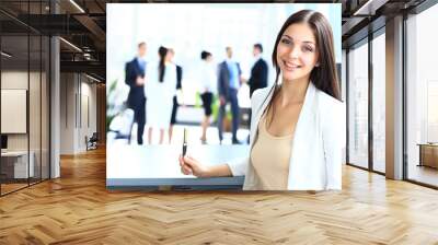 Young businesswoman and her colleagues Wall mural