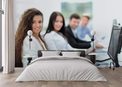 Young  businesswoman working in an office using computer with co Wall mural