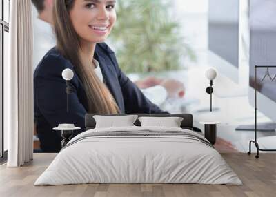 young employee sitting at a Desk Wall mural