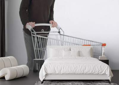 young man with a shopping cart steps forward Wall mural