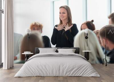 young woman telling about something to her colleagues . Wall mural