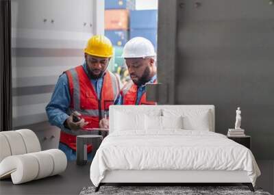 Two black african male professional engineers doing routine checkup on a container logistic shipping yard ensuring all containers are following procedure and safety regulation Wall mural