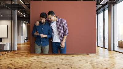 looking at the phone together Wall mural