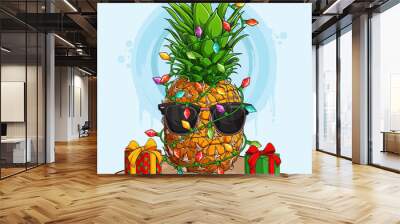 Funny Christmas Pineapple in sunglasses and surrounded by Christmas tree lights and gifts Wall mural