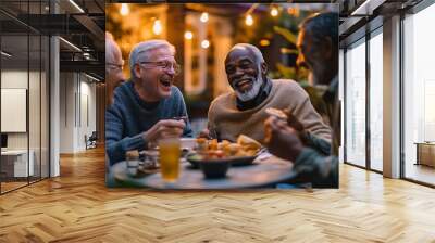 Senior group of friends laughing and enjoying dinner outdoors. Wall mural