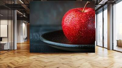 Black background, a red apple on the plate, with a black background and dark tones. Wall mural