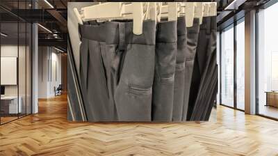 Row of school clothes for boys and girls in the shop Wall mural