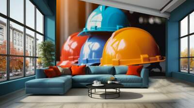 Orange, yellow, and blue hard safety helmet hats for safety projects  Wall mural