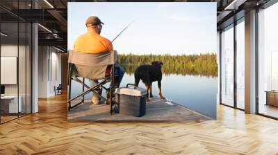 A man fishing on a lake on a wooden dock in Ontario Canada Wall mural