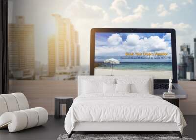 Travel, holiday , vacation planning concept : laptop with website book your dream vacation on screen at office work space for business people planning trip for relax on holiday Wall mural