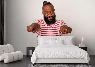 African american man with beard isolated on pink background cheerful smiles pointing to front. Wall mural