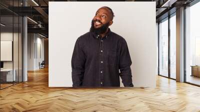 African american man with beard isolated on pink background relaxed and happy laughing, neck stretched showing teeth. Wall mural