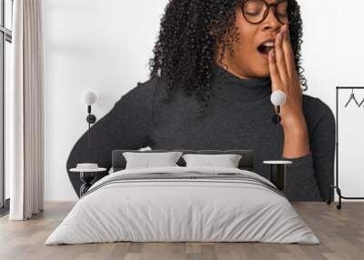 african american woman in studio setting yawning showing a tired gesture covering mouth with hand. Wall mural