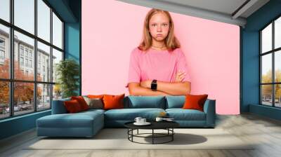 Caucasian teen girl isolated on pink background blows cheeks, has tired expression. Facial expression concept. Wall mural