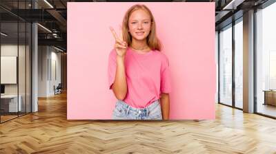 Caucasian teen girl isolated on pink background showing number two with fingers. Wall mural