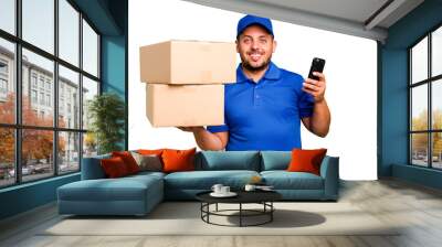 Delivery caucasian man delivering packages and using his mobile phone isolated Wall mural