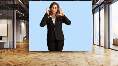 Full body young busines woman showing number eight Wall mural