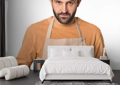 Hispanic male baker with sweet pastries in studio Wall mural