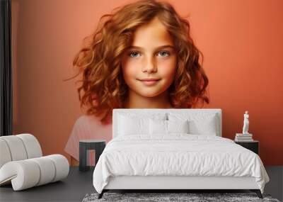 Portrait of a cute little girl with curly hair. Studio shot. Wall mural