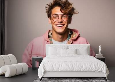 Portrait of a handsome young man with glasses and a pink jacket Wall mural