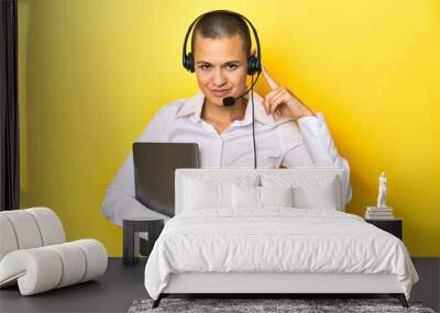 Virtual assistant with headset and laptop, yellow studio background Wall mural