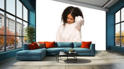 Young african american curly woman isolated having a neck pain due to stress, massaging and touching it with hand. Wall mural