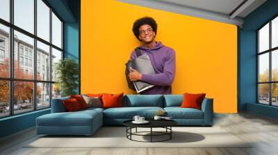 Young african american student man smiling confident and crossing arms, looking up Wall mural