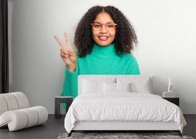 Young african american woman isolated on white background showing number two with fingers. Wall mural