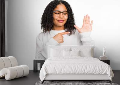 Young african american woman with curly hair cut out isolated smiling cheerful showing number five with fingers. Wall mural