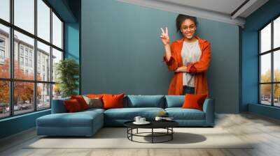 young black african american girl with blue eyes showing number two Wall mural