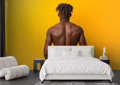 Young black man shirtless wearing swimsuit from behind, looking back. Wall mural