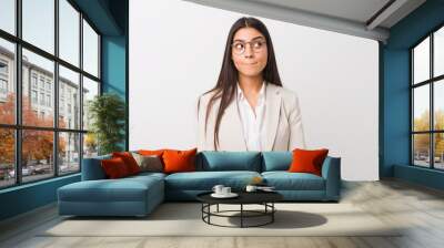 Young business arab woman isolated against a white background confused, feels doubtful and unsure. Wall mural