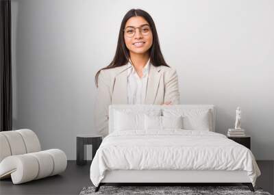 Young business arab woman isolated against a white background who feels confident, crossing arms with determination. Wall mural