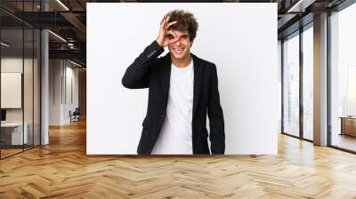 Young caucasian business man against a white background isolated excited keeping ok gesture on eye. Wall mural