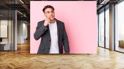 Young caucasian business man posing isolated relaxed thinking about something looking at a copy space. Wall mural