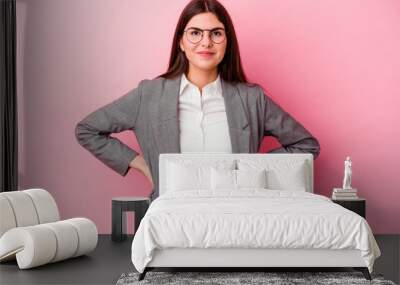 Young caucasian business woman isolated on pink background confident keeping hands on hips. Wall mural