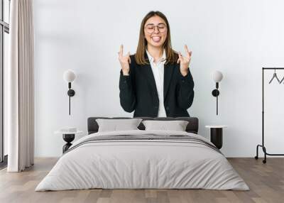 Young caucasian business woman showing rock gesture with fingers Wall mural