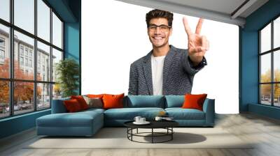 Young caucasian handsome man isolated joyful and carefree showing a peace symbol with fingers. Wall mural